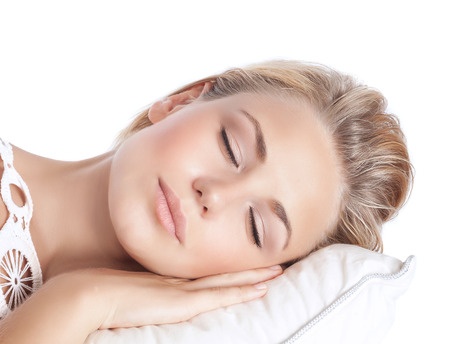 36974184 - closeup portrait of cute blond serene girl sleeping, attractive gentle female with closed eyes lying down on the pillow isolated on white background, peace and harmony concept