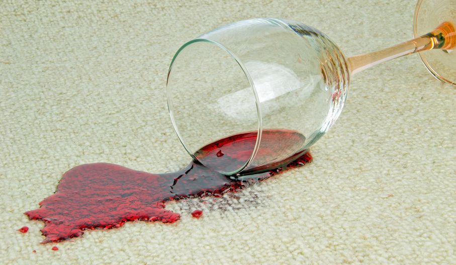 21677053 - a spilled glass of red wine on a carpet