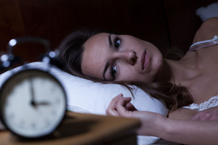 32559585 - woman lying in bed suffering from insomnia